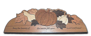 Wood door crown with an inlaid harvest pumpkin and leaves design