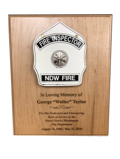 Wood memorial plaque with a fire inspector helmet shield