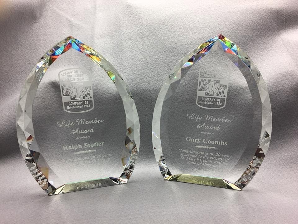 Two etched crystal Life Member awards with a rescue squad emblem